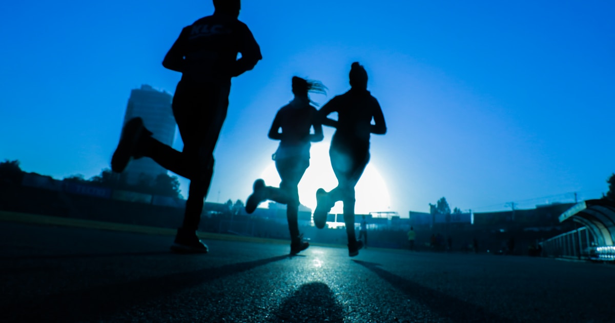 A barefoot runner approaching the finish line of a marathon